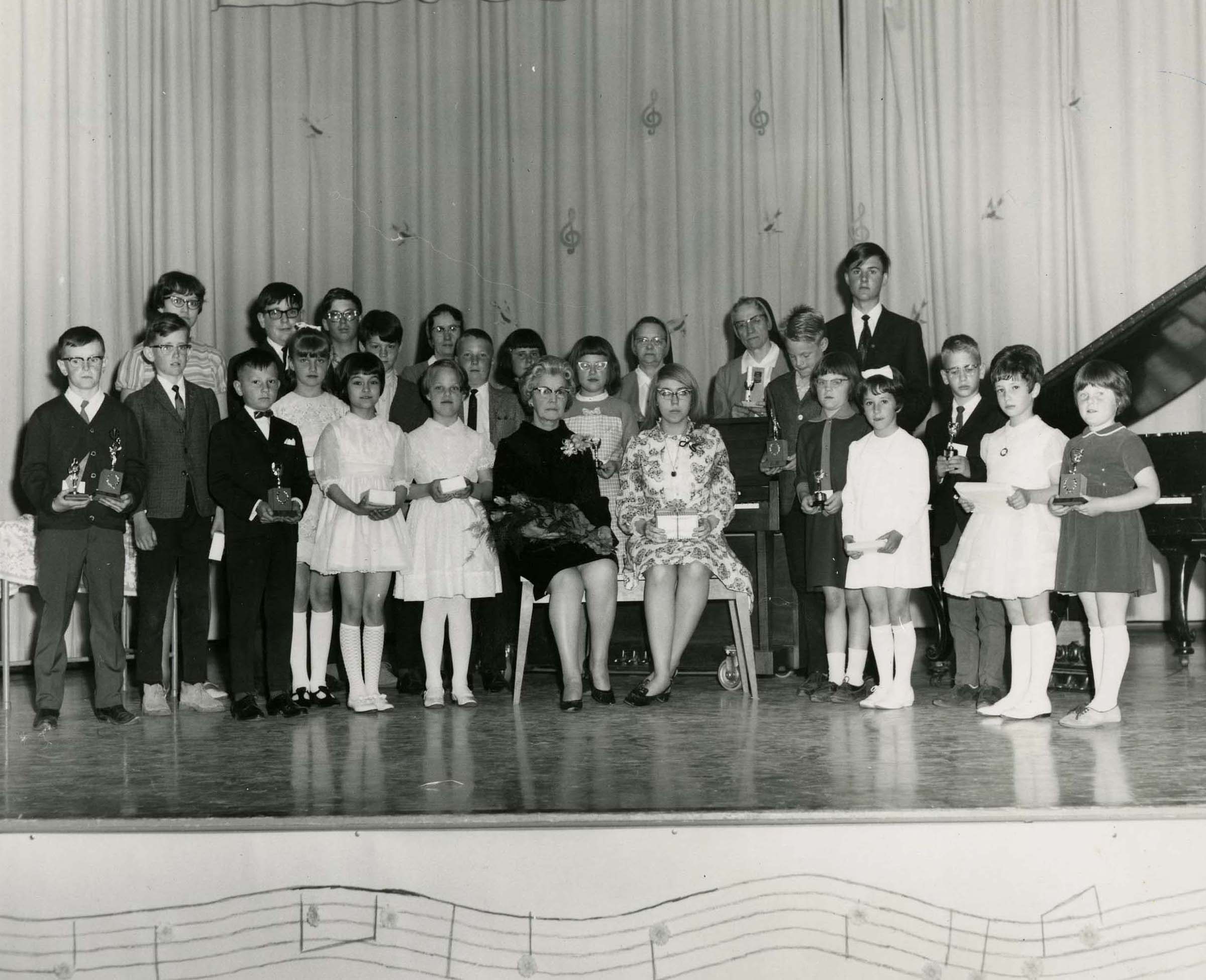 Group of students and teachers on stage at Blue Quills Sacred Heart