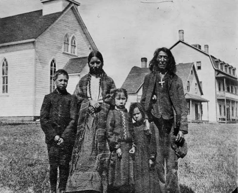 family outside building at Ermineskin Hobbema school