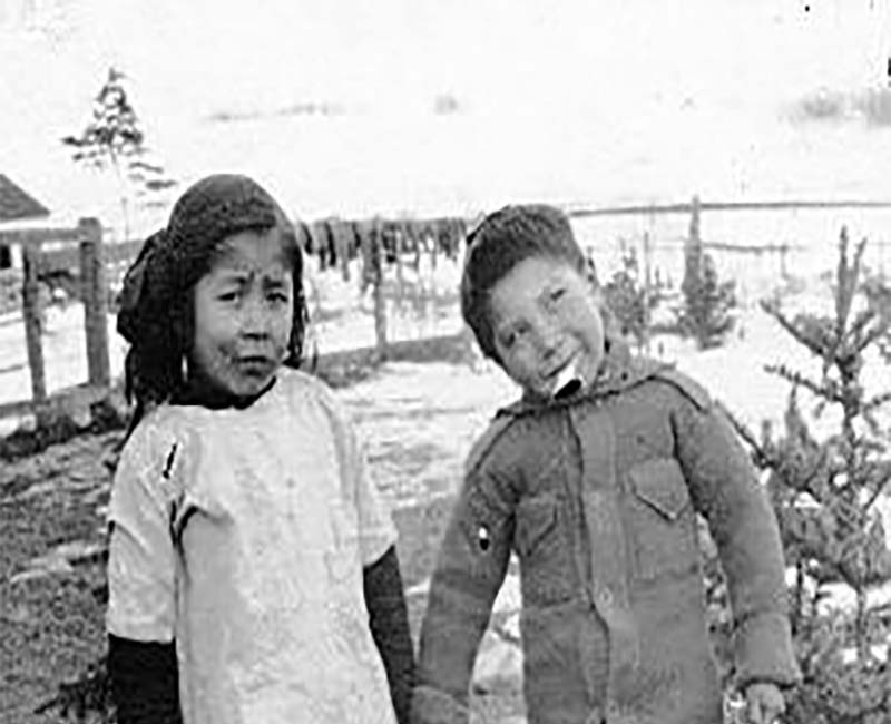 Two students outside at Sarcee St. Barnabas school