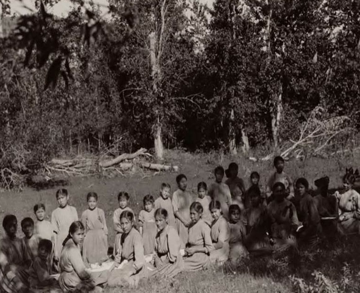 group of students sitting outside Lejac Stuart Lake school