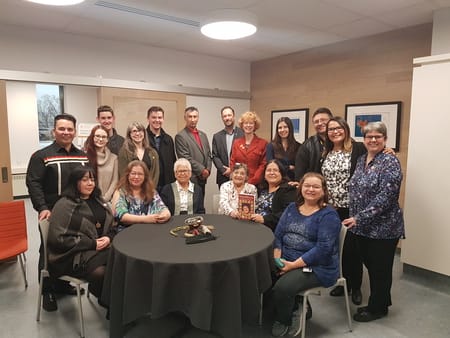 group of people sitting and standing around a table from NCTR and Dalhousie partnership