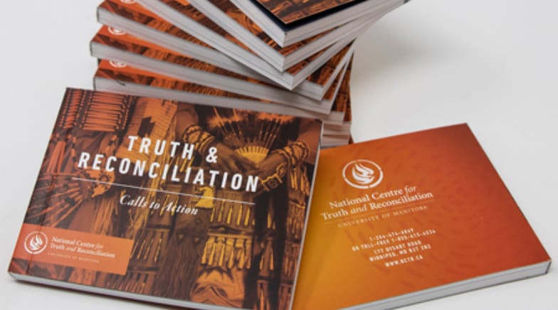 A stack of Truth and Reconciliation Calls to Action booklets.