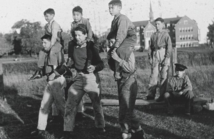 Group of students, standing sitting, a sitting on each others shoulders.