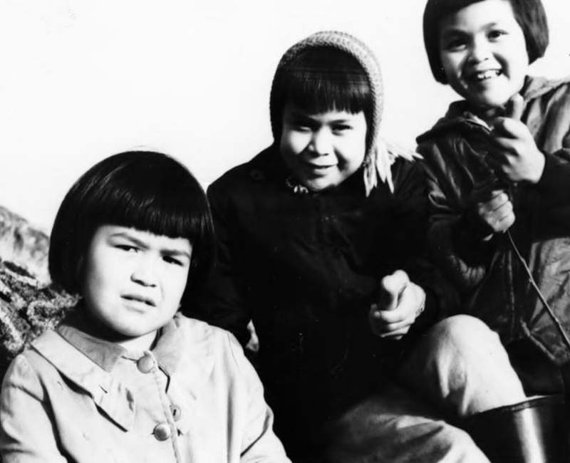 Three students sitting outside