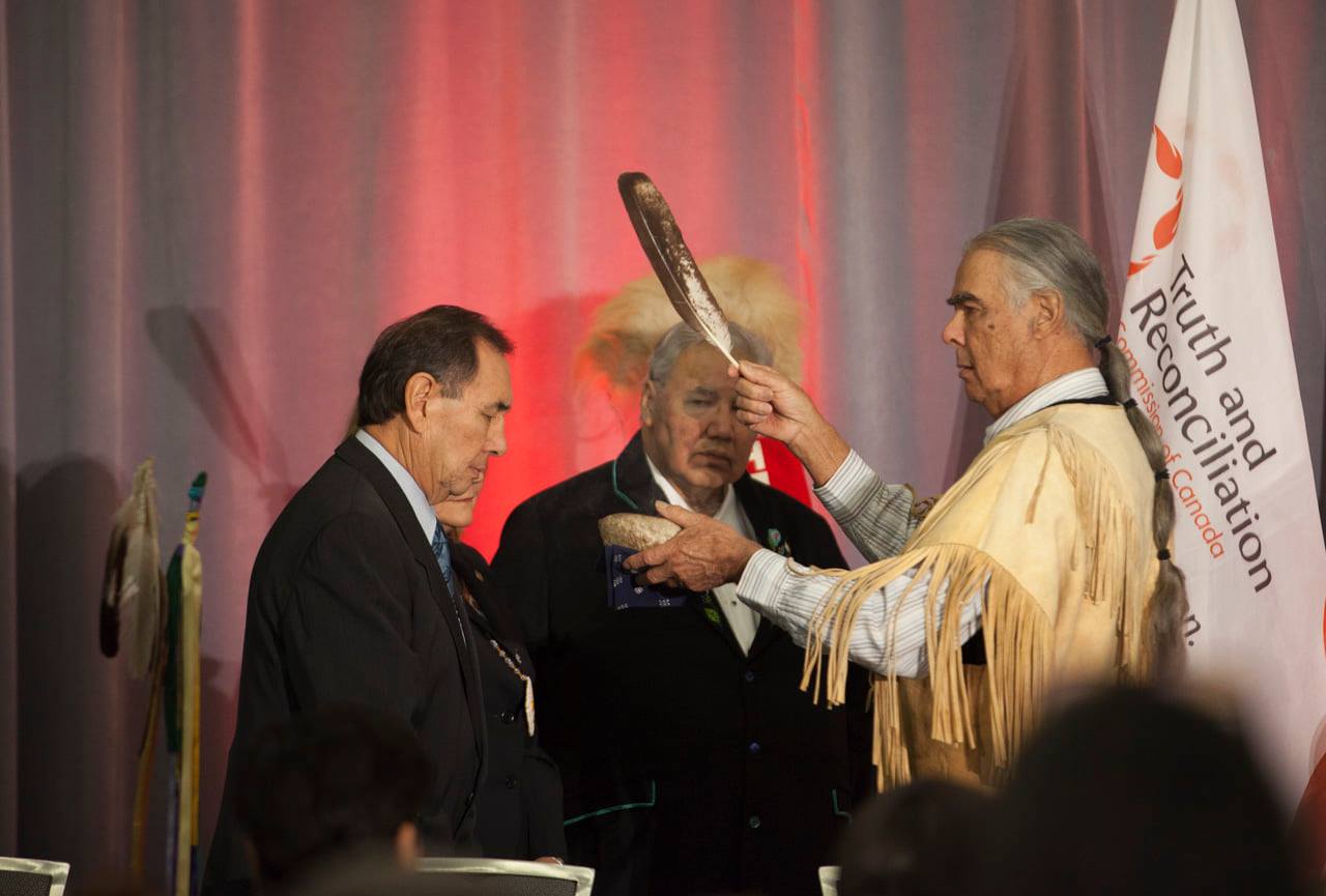 Four people on stage at TRC closing ceremony