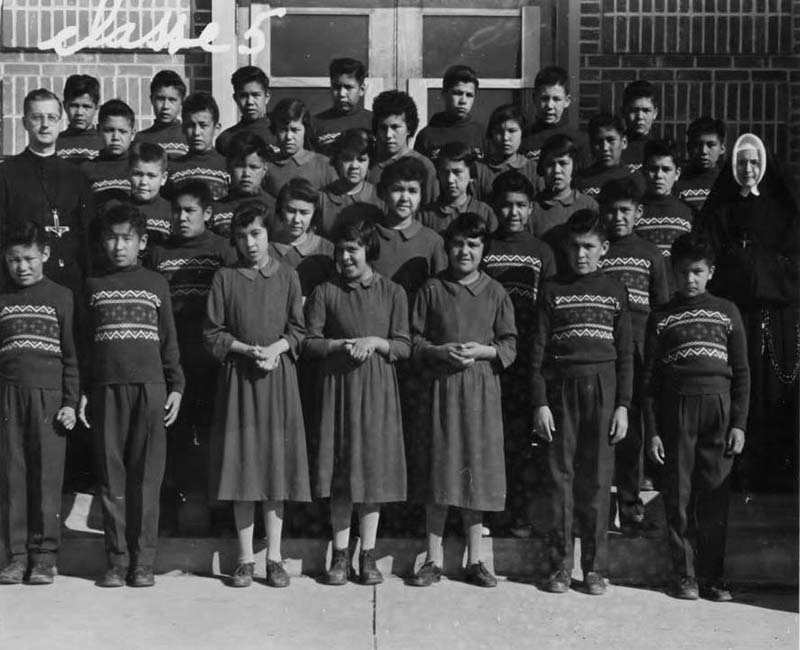 Group od students posing for photo outside Amos school