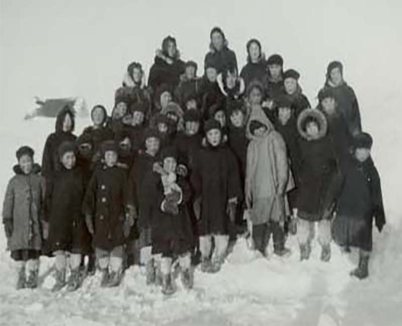 Group of people standing outside in the snow 