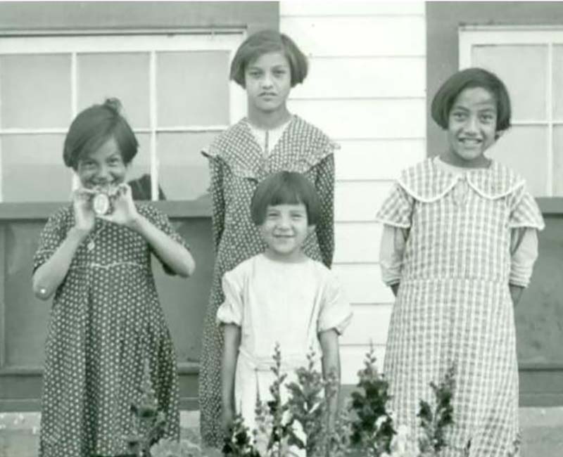 Group of four students outside St. Phillips school