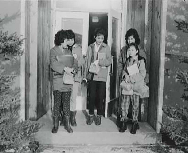 Group of five students outside Yukon Hall school 