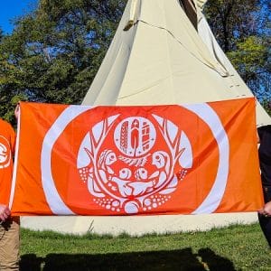 Product image of Survivors' Flag with white logo and orange background