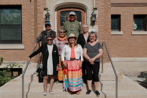 Survivors stand on the stairs outside Chancellor’s Hall.